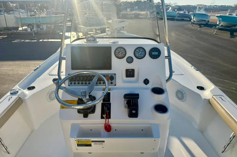 Slide: The Image of 2020 Key West 230 Bay Reef boat dashboard with steering wheel and gauges. - 26