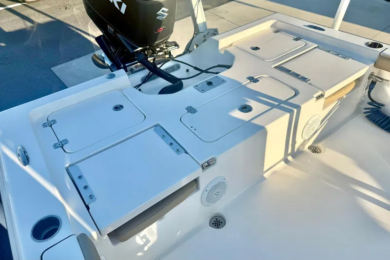 Slide: The Image of 2020 Key West 230 Bay Reef boat deck with storage compartments and Suzuki outboard motor. - 30