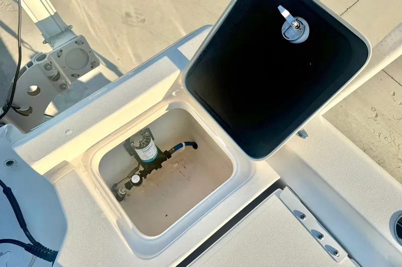 Slide: The Image of Open compartment on 2020 Key West 230 Bay Reef boat, showing internal components. - 32