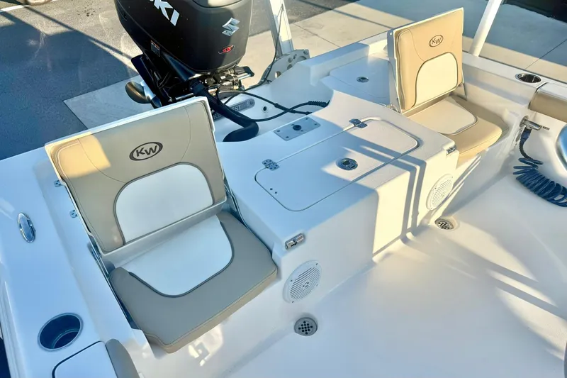 Slide: The Image of 2020 Key West 230 Bay Reef boat interior with cushioned seating and Suzuki outboard motor. - 34