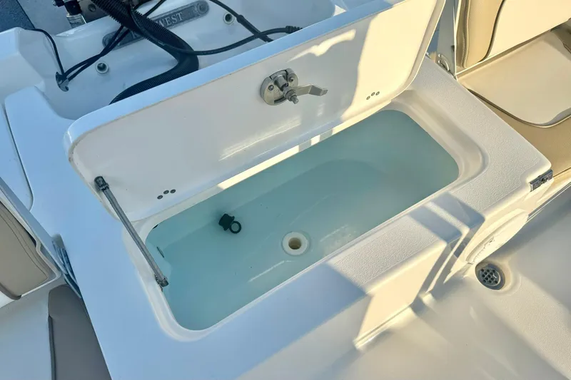 Slide: The Image of Livewell on 2020 Key West 230 Bay Reef boat, featuring a clean, white interior. - 36