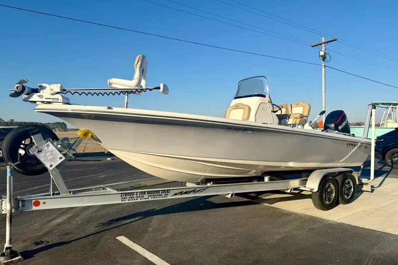 Slide: The Image of 2020 Key West 230 Bay Reef boat on trailer, parked outdoors under clear sky. - 5