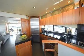 Slide: The Image of Luxurious dining area on 2013 Sunseeker Manhattan 73 yacht with elegant wood finishes. - 12