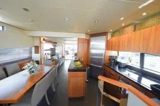 Slide: The Image of Luxurious interior of 2013 Sunseeker Manhattan 73 yacht with dining area and modern kitchen. - 13