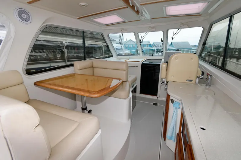 Slide: The Image of Interior of 2010 Back Cove 33 boat with seating and dining area. - 11