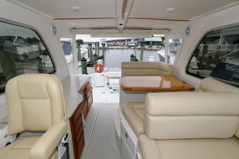Slide: The Image of Interior view of 2010 Back Cove 33 yacht with beige seating and wooden accents. - 14