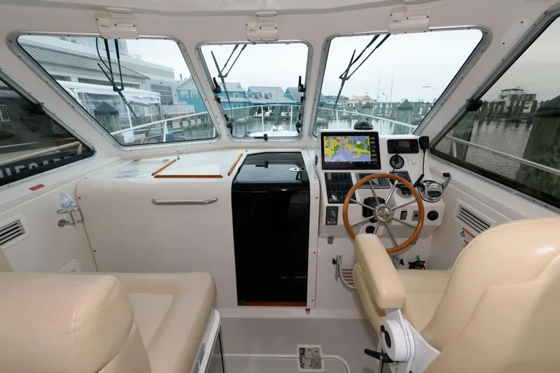 Slide: The Image of Interior view of 2010 Back Cove 33 boat cockpit with navigation equipment and steering wheel. - 15