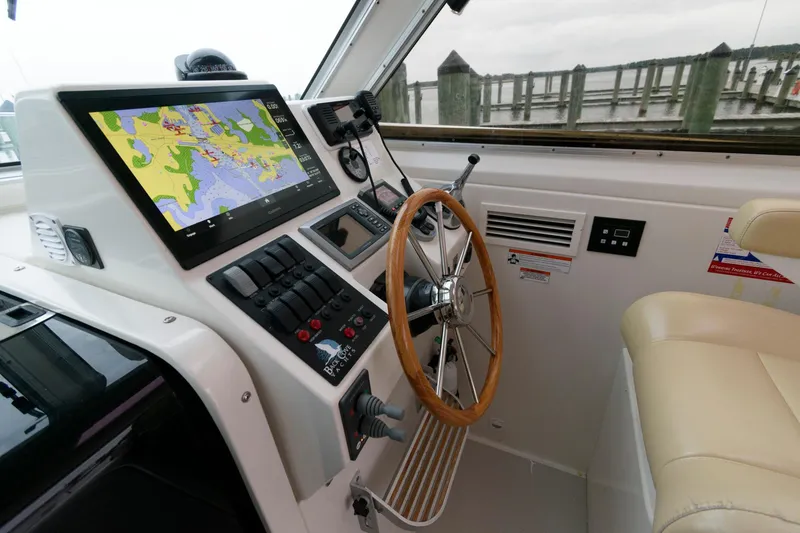 Slide: The Image of Helm of 2010 Back Cove 33 boat with navigation display and wooden steering wheel. - 17