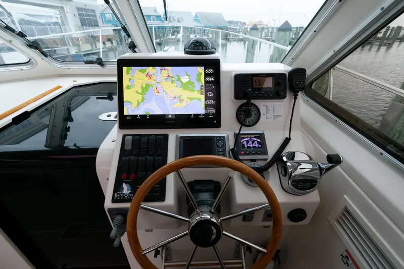 Slide: The Image of Helm of 2010 Back Cove 33 boat with navigation equipment and wooden steering wheel. - 18