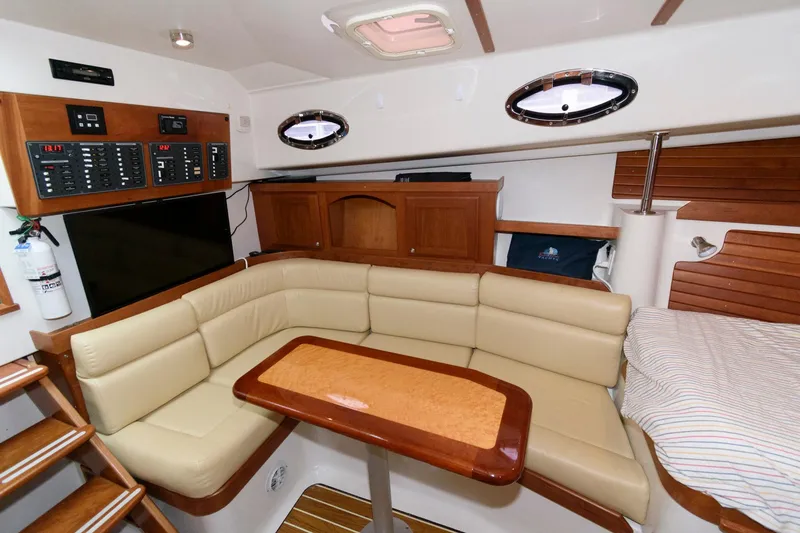Slide: The Image of Luxurious interior of 2010 Back Cove 33 yacht with beige seating and wooden accents. - 21