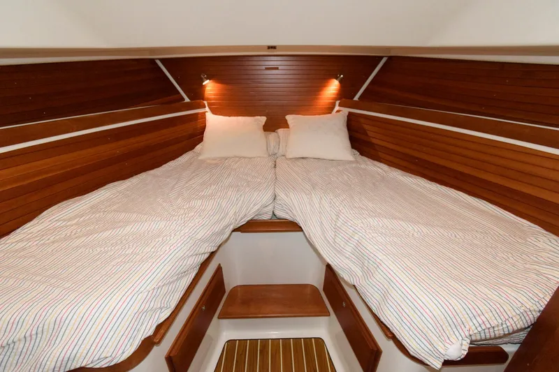 Slide: The Image of 2010 Back Cove 33 cabin with twin beds and wooden interior. - 22