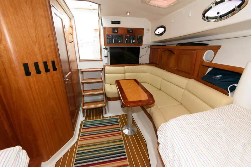 Slide: The Image of Interior of 2010 Back Cove 33 yacht with cozy seating and striped rug. - 23