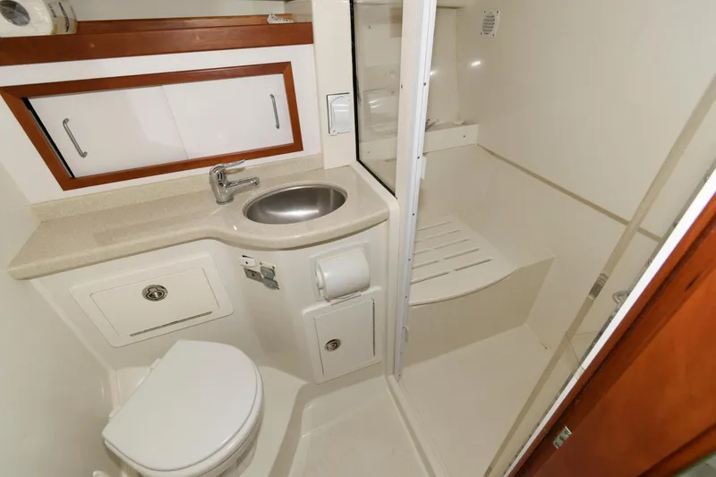 Slide: The Image of 2010 Back Cove 33 yacht bathroom with sink, toilet, and shower area. - 24