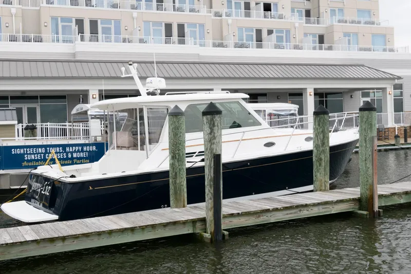 Slide: The Image of 2010 Back Cove 33 yacht docked near waterfront building. - 3