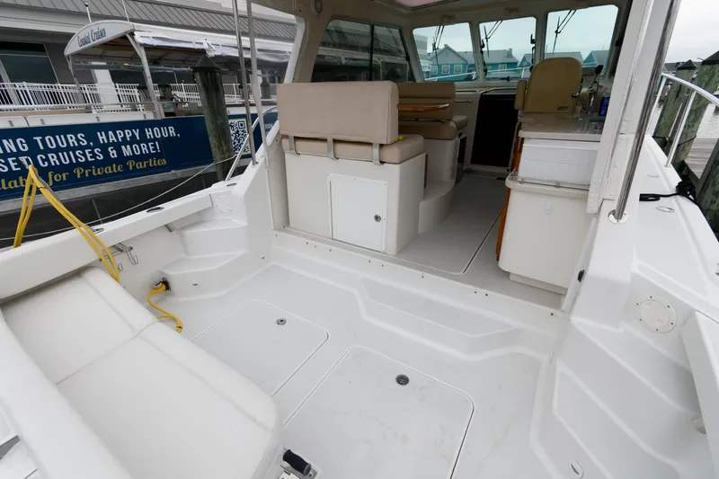 Slide: The Image of 2010 Back Cove 33 boat interior with seating and storage, docked at marina. - 7