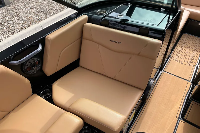 Slide: The Image of 2023 MasterCraft NXT24 boat interior with tan seating and sleek design. - 10