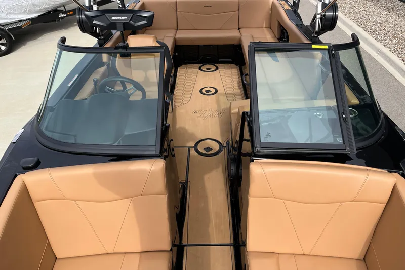 Slide: The Image of 2023 MasterCraft NXT24 boat interior with tan seating and sleek design. - 12