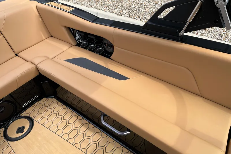 Slide: The Image of 2023 MasterCraft NXT24 boat interior with tan seating and stylish flooring. - 13