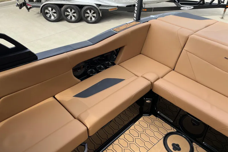 Slide: The Image of 2023 MasterCraft NXT24 boat interior with tan seating and cup holders. - 14