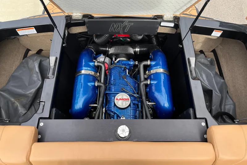 Slide: The Image of 2023 MasterCraft NXT24 engine compartment with Ilmor engine, showcasing blue components. - 15