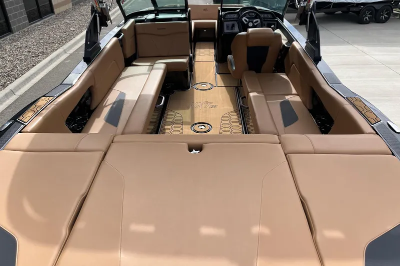 Slide: The Image of 2023 MasterCraft NXT24 boat interior with tan seating and modern dashboard design. - 8