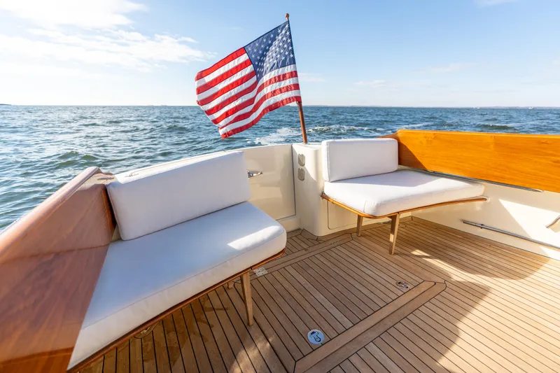 Slide: The Image of Hinckley Talaria 44 MKII Express 2010 yacht deck with American flag, ocean view. - 12