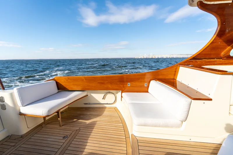 Slide: The Image of Hinckley Talaria 44 MKII Express 2010 yacht deck with white seating and ocean view. - 13