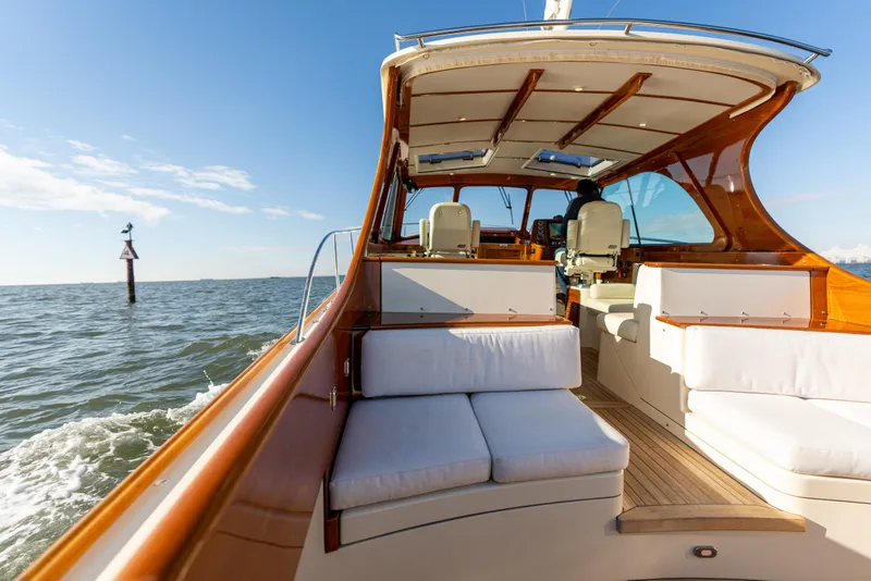 Slide: The Image of Hinckley Talaria 44 MKII Express 2010 cruising on open water, featuring elegant wooden interior. - 16
