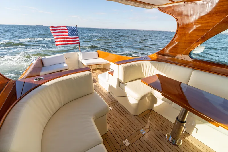 Slide: The Image of Luxurious 2010 Hinckley Talaria 44 MKII Express yacht with elegant seating and American flag. - 17