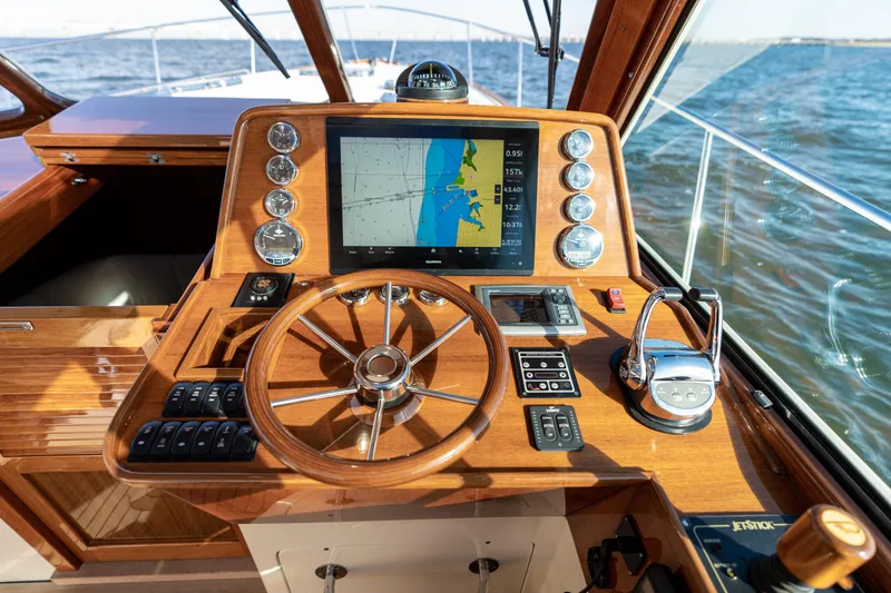 Slide: The Image of Helm of 2010 Hinckley Talaria 44 MKII Express with navigation display and wooden steering wheel. - 30