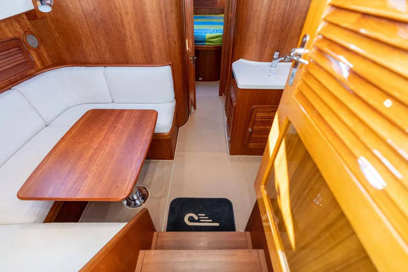 Slide: The Image of Interior of 2010 Hinckley Talaria 44 MKII Express with wood finish and white seating. - 31