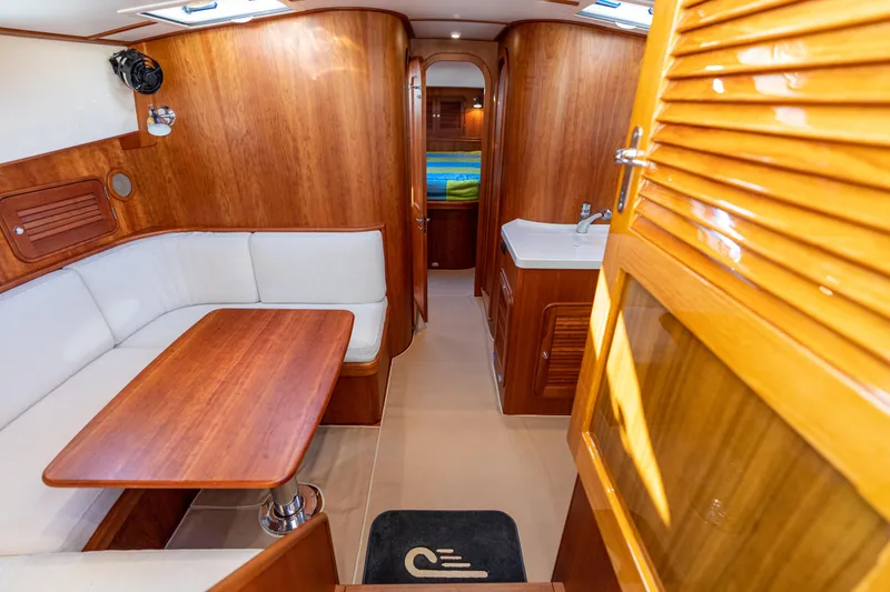 Slide: The Image of Luxurious interior of 2010 Hinckley Talaria 44 MKII Express yacht with wood finish and seating area. - 34