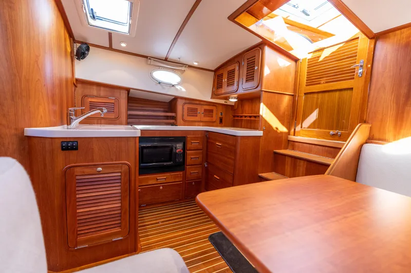 Slide: The Image of Interior of 2010 Hinckley Talaria 44 MKII Express yacht with wooden cabinetry and modern amenities. - 37