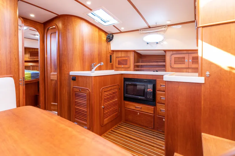 Slide: The Image of Luxurious 2010 Hinckley Talaria 44 MKII Express yacht interior with wood finish and modern amenities. - 40