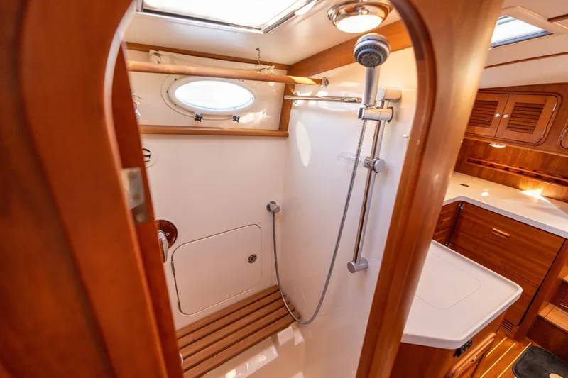 Slide: The Image of Luxurious 2010 Hinckley Talaria 44 MKII Express yacht bathroom with wooden accents and shower. - 48