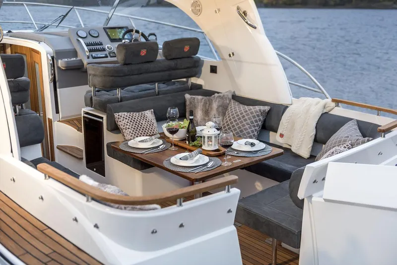 Slide: The Image of Manufacturer Provided Image: Luxurious interior of 2026 Marex 310 Sun Cruiser with set dining table. - 9