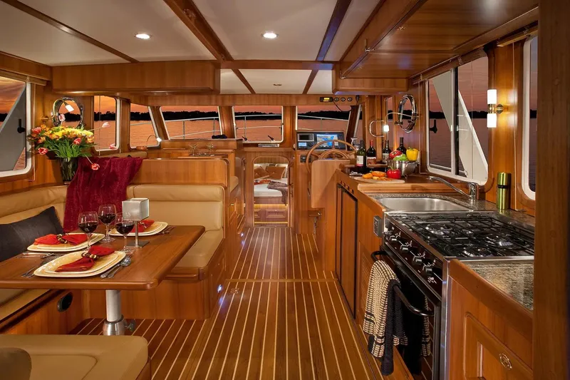 The Image of Luxurious interior of 2025 Helmsman Trawlers 38 Sedan with elegant wood finish and dining setup. - 1