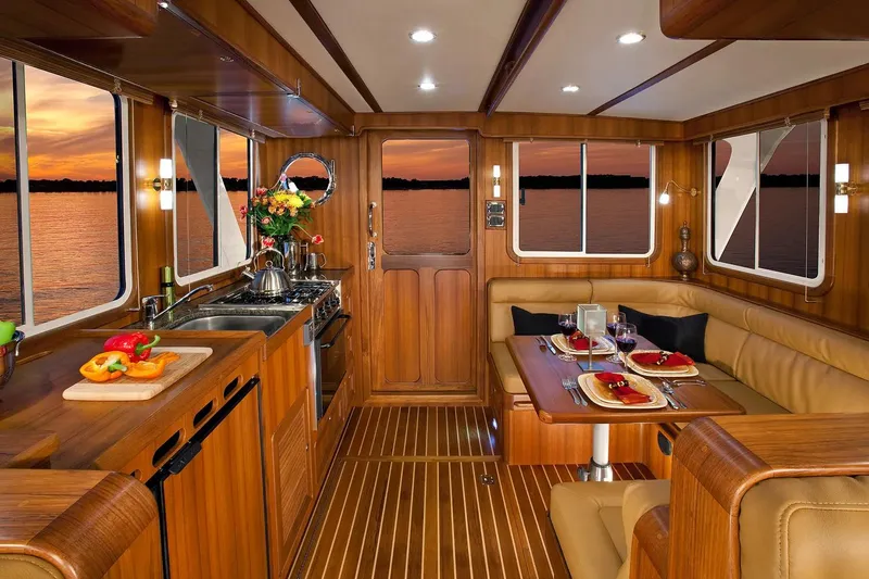 Slide: The Image of Luxurious interior of 2025 Helmsman Trawlers 38 Sedan with elegant wood finish and dining setup. - 13
