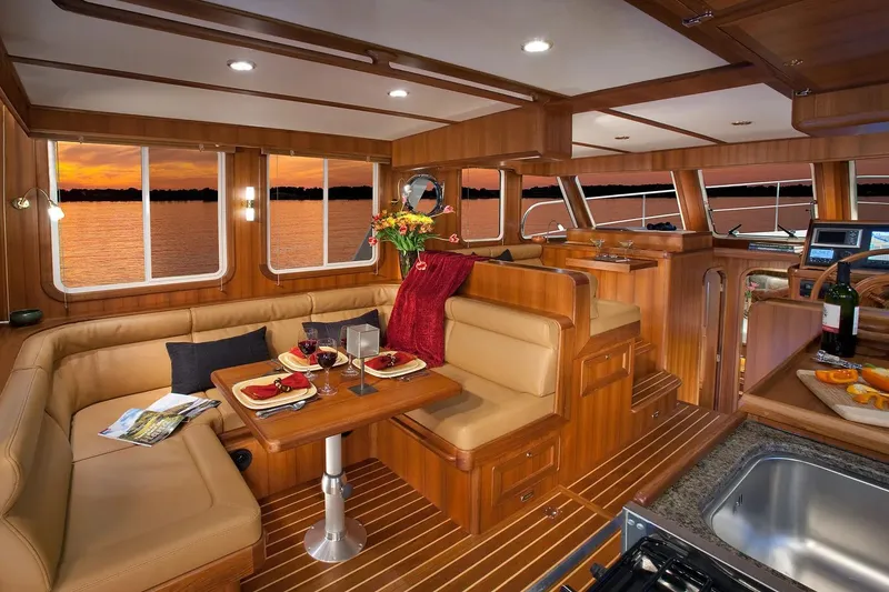 Slide: The Image of Luxurious interior of 2025 Helmsman Trawlers 38 Sedan with elegant dining area and sunset view. - 17