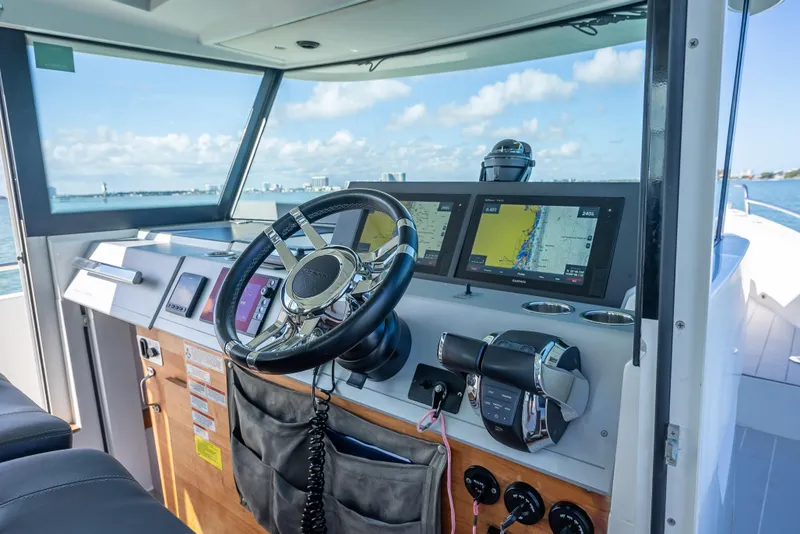 Slide: The Image of Interior view of 2017 Axopar 37 XC Cross Cabin boat cockpit with navigation screens. - 12