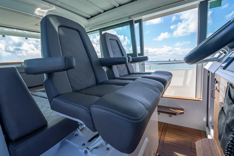 Slide: The Image of Luxurious interior of 2017 Axopar 37 XC Cross Cabin with leather seating and ocean view. - 14