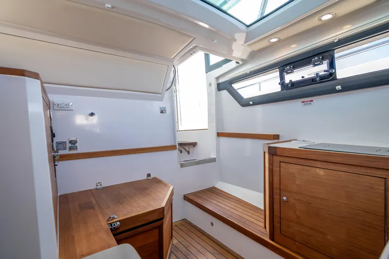 Slide: The Image of Interior of 2017 Axopar 37 XC Cross Cabin with wood accents and modern design. - 16