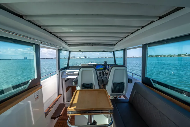 Slide: The Image of Interior view of 2017 Axopar 37 XC Cross Cabin, overlooking serene waters. - 8