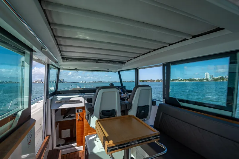 Slide: The Image of Interior of 2017 Axopar 37 XC Cross Cabin with ocean view and seating area. - 9