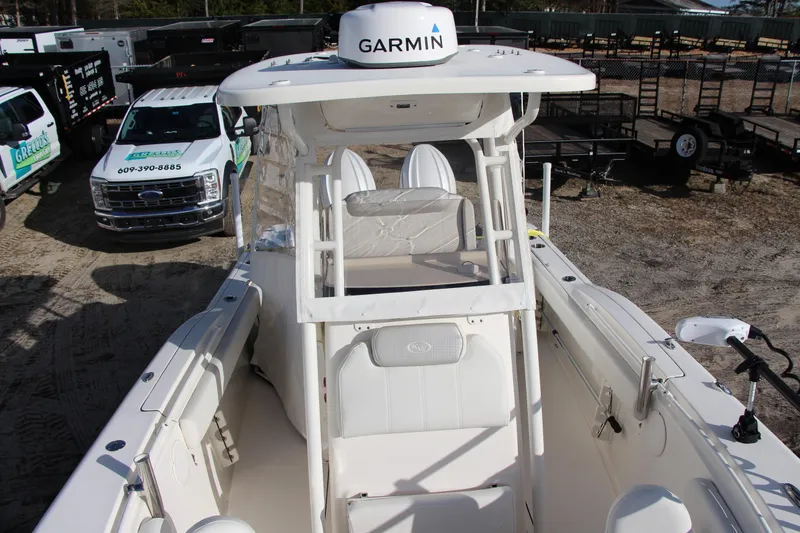 Slide: The Image of 2024 Key West 244 Center Console boat with Garmin equipment, parked near trucks. - 13