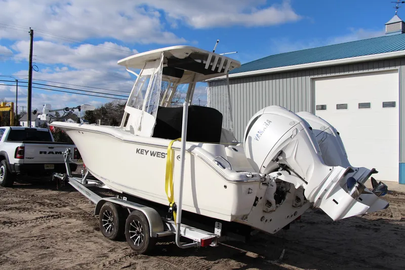 Slide: The Image of 2024 Key West 244 Center Console boat on trailer, parked outdoors. - 2