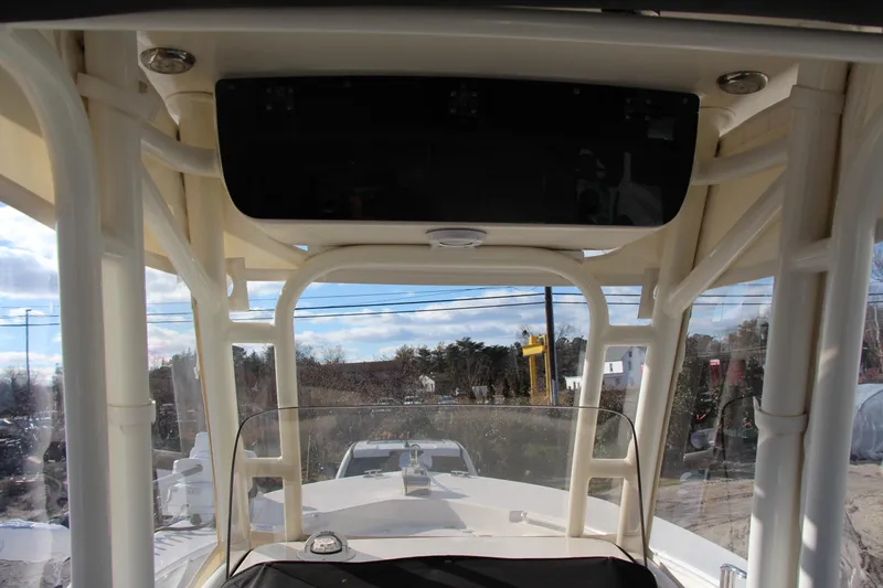 Slide: The Image of 2024 Key West 244 Center Console boat interior with windshield and overhead console. - 6