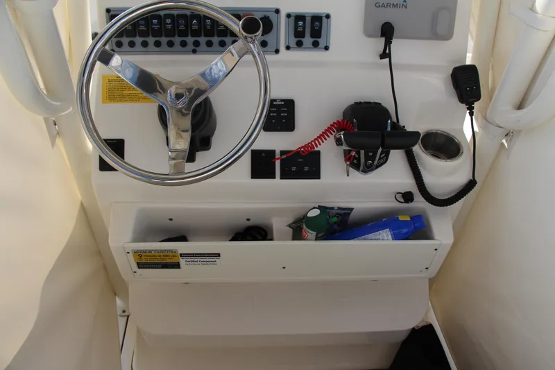 Slide: The Image of 2024 Key West 244 Center Console boat dashboard with steering wheel and controls. - 9