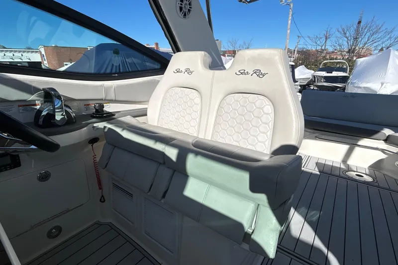 Slide: The Image of 2021 Sea Ray Sundancer 320 cockpit with dual helm seats and modern controls. - 10