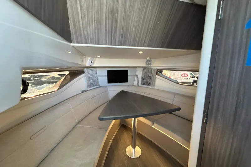 Slide: The Image of Interior of 2021 Sea Ray Sundancer 320, featuring a cozy seating area and modern design. - 13